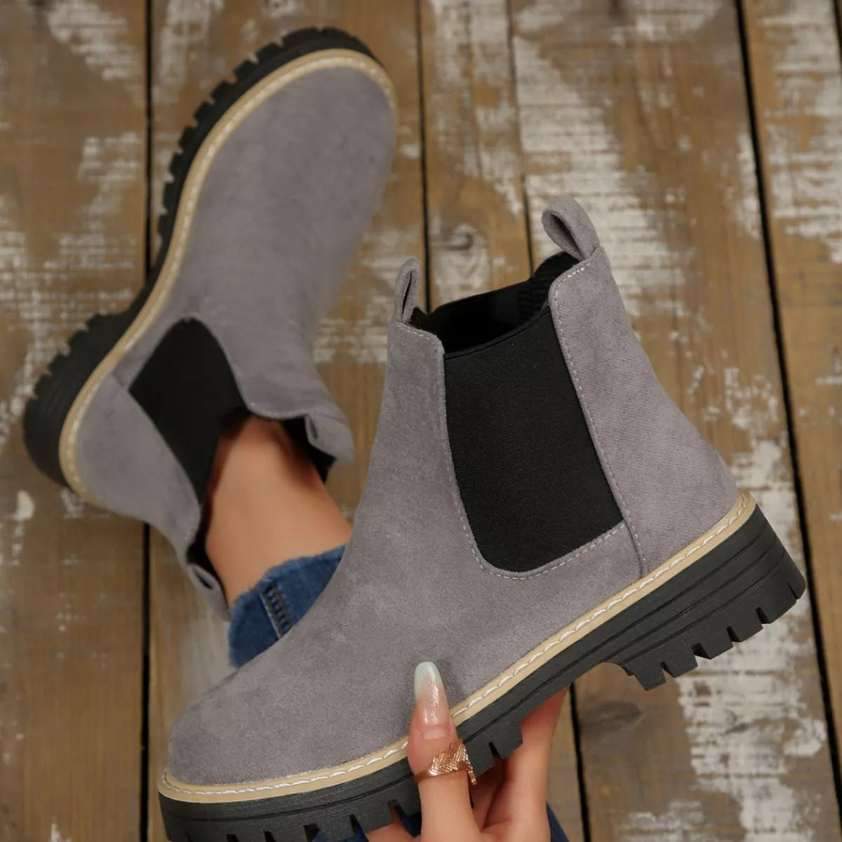 Gray suede round toe Chelsea ankle boots with black elastic side panels, mid-block heels and lug soles.