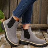 Gray suede round toe Chelsea ankle boots with black elastic side panels, mid-block heels and lug soles.