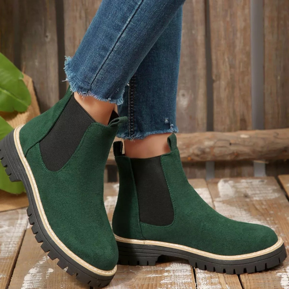 Green suede round toe Chelsea ankle boots with black elastic side panels, mid-block heels and lug soles.