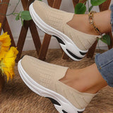 Beige women’s round toe mesh slip-on sneakers with a lightweight knit upper and sporty white and black rubber sole.