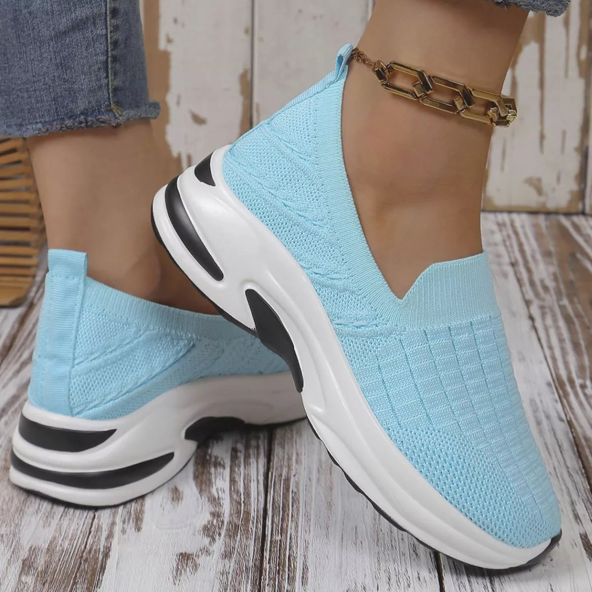 Sky blue women’s round toe mesh slip-on sneakers with a lightweight knit upper and sporty white and black rubber sole.