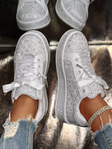 White round toe women’s sneakers with rhinestone embellishments, satin-style ribbon laces and pearl-inspired accents.