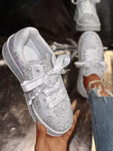 White round toe women’s sneakers with rhinestone embellishments, satin-style ribbon laces and pearl-inspired accents.