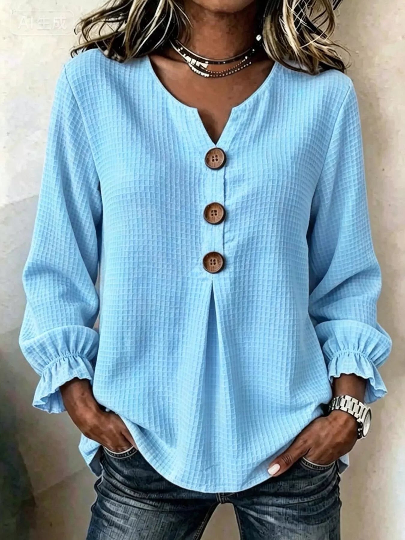 Women’s sky-blue waffle knit flounce sleeve top with button front detail and ruffled cuffs.