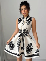 Woman wearing a white dress with black pattern against a gray background
