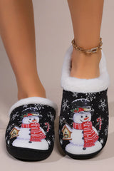 Black snowman round toe slippers with white faux fur trim, festive snowflake print, red scarf design, and black flat soles.