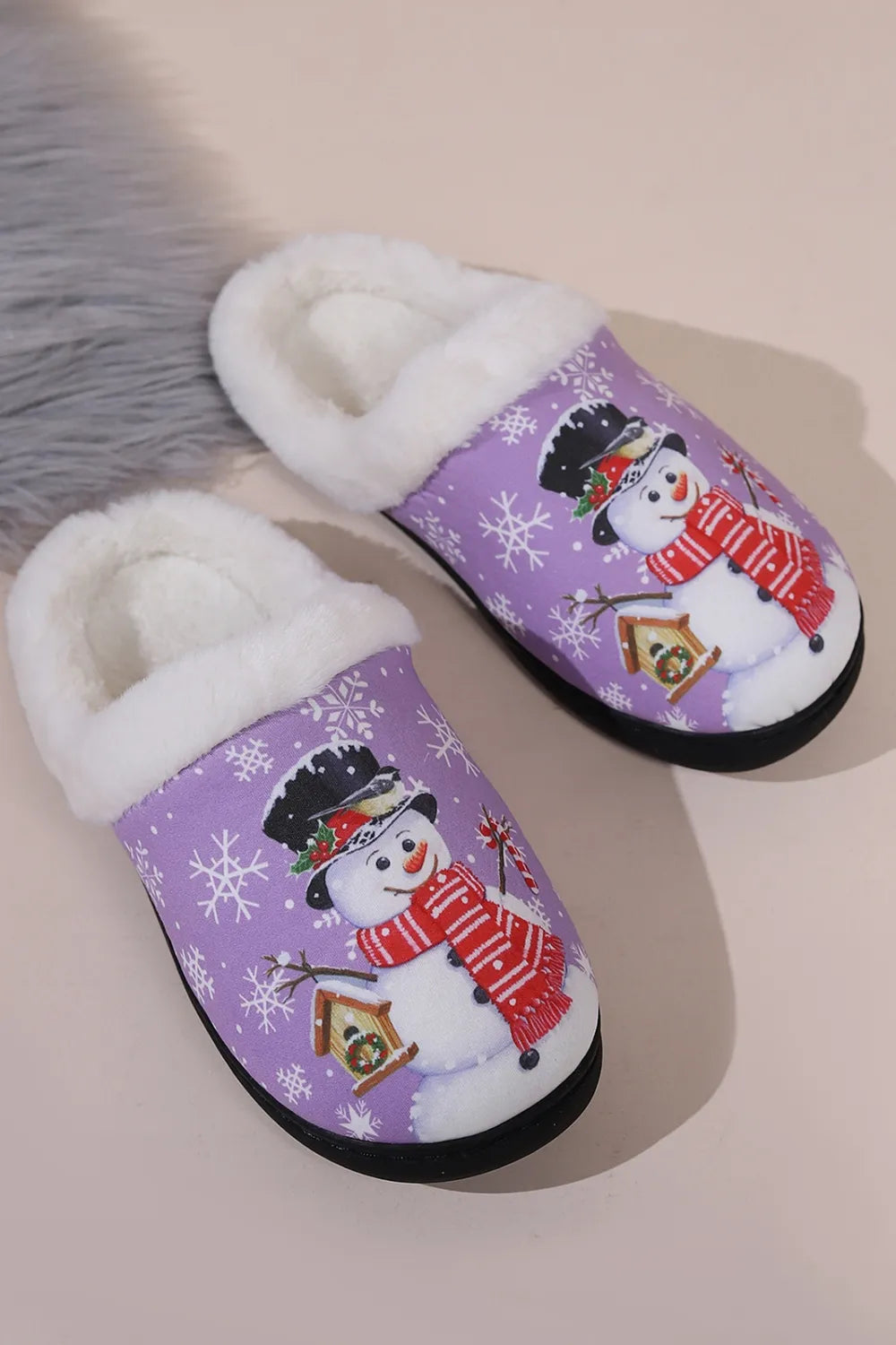 Heliotrope purple snowman slippers with white faux fur lining, festive snowflakes, smiling snowman print, and round toe design.