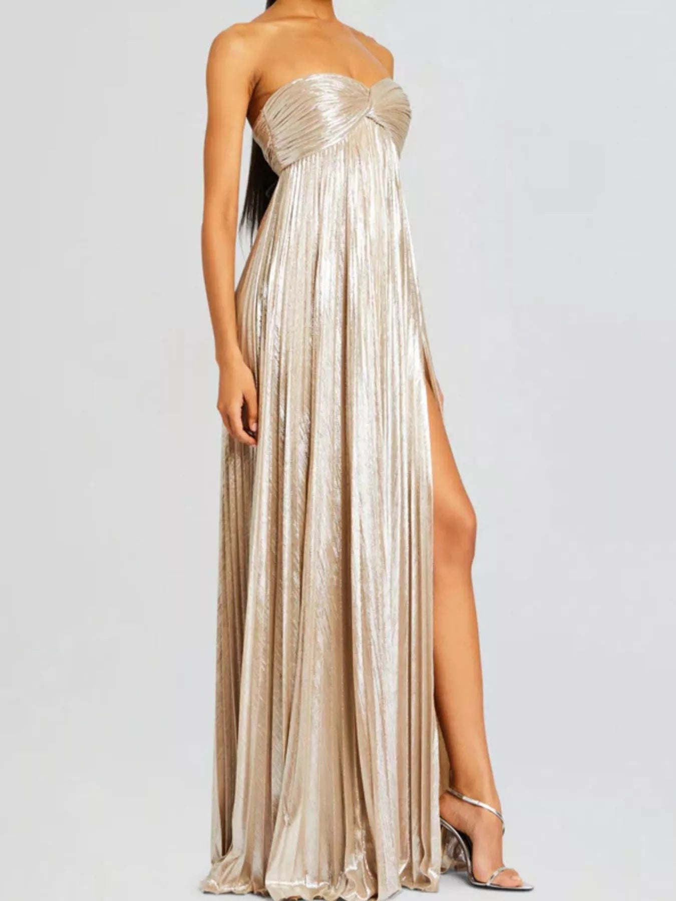 Beige strapless gown with a high slit on a white background