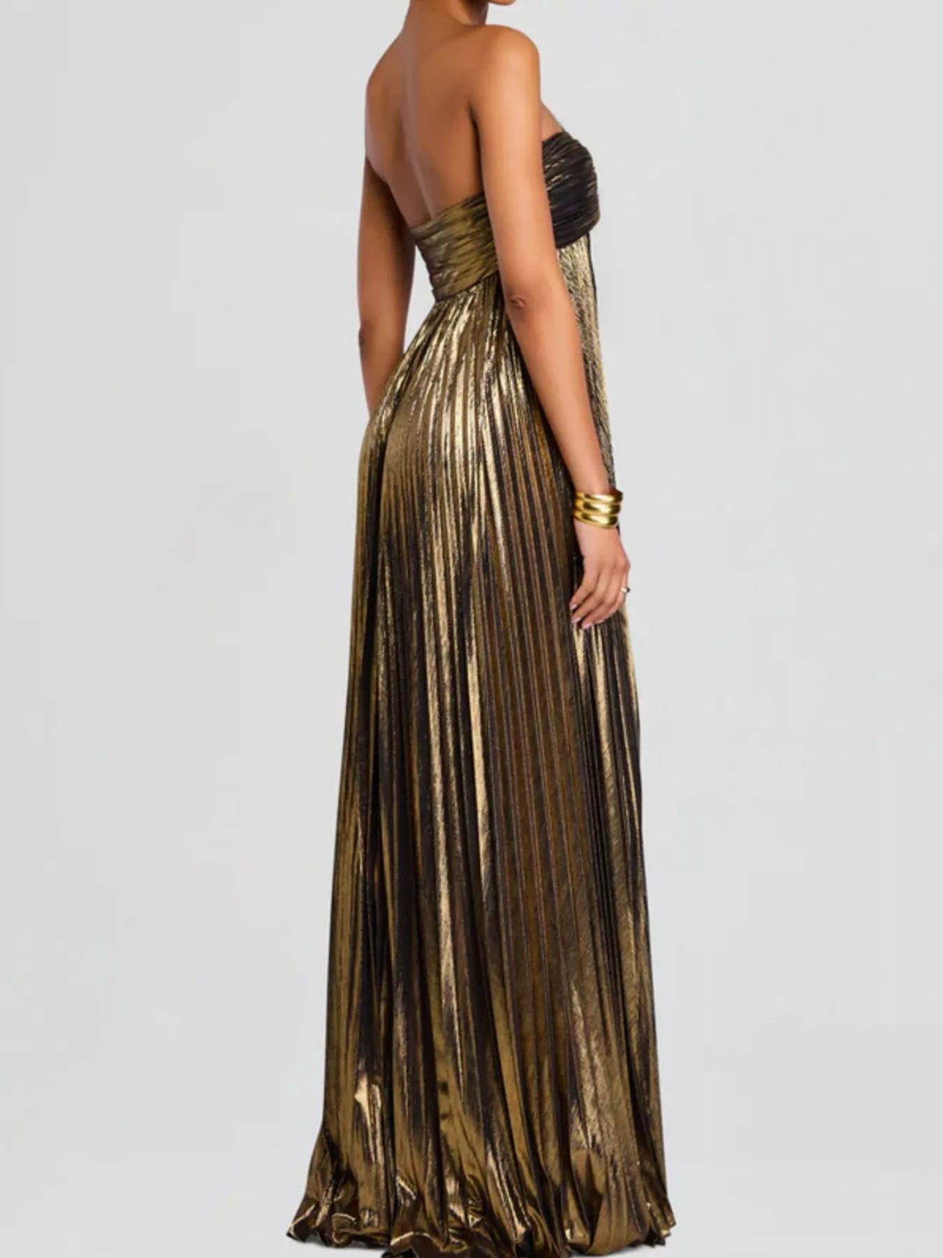 Khaki pleated evening gown on a plain background showing side of dress.