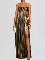 Gold strapless gown with a high slit on a white background