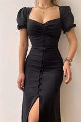 Woman wearing a black sweetheart-neck midi dress with puff sleeves, ruched detailing, and a button-front slit.