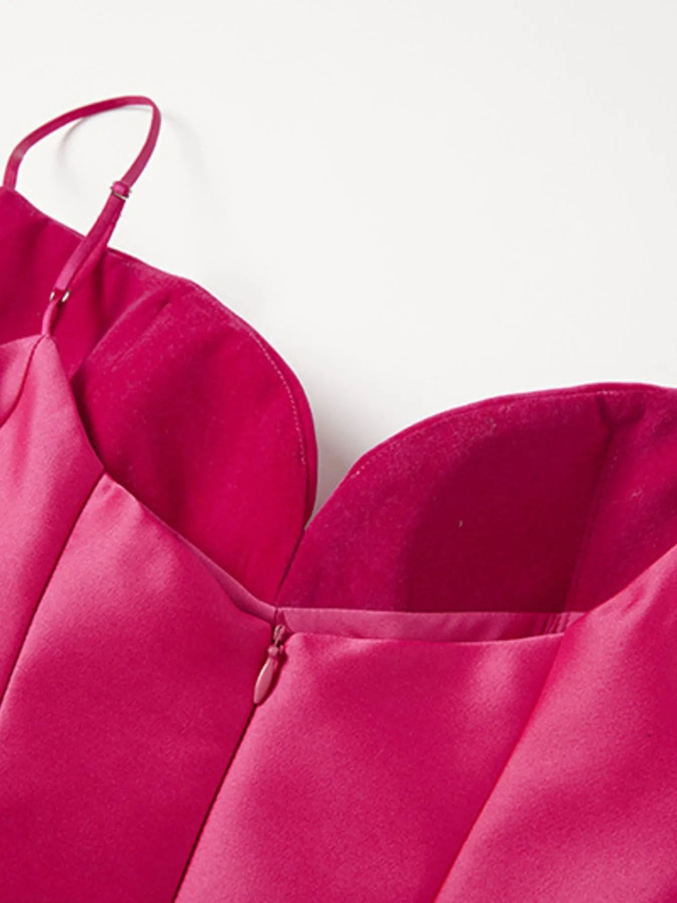 Close-up of a pink dress with thin straps on a white background