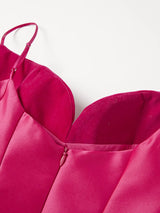 Close-up of a pink dress with thin straps on a white background