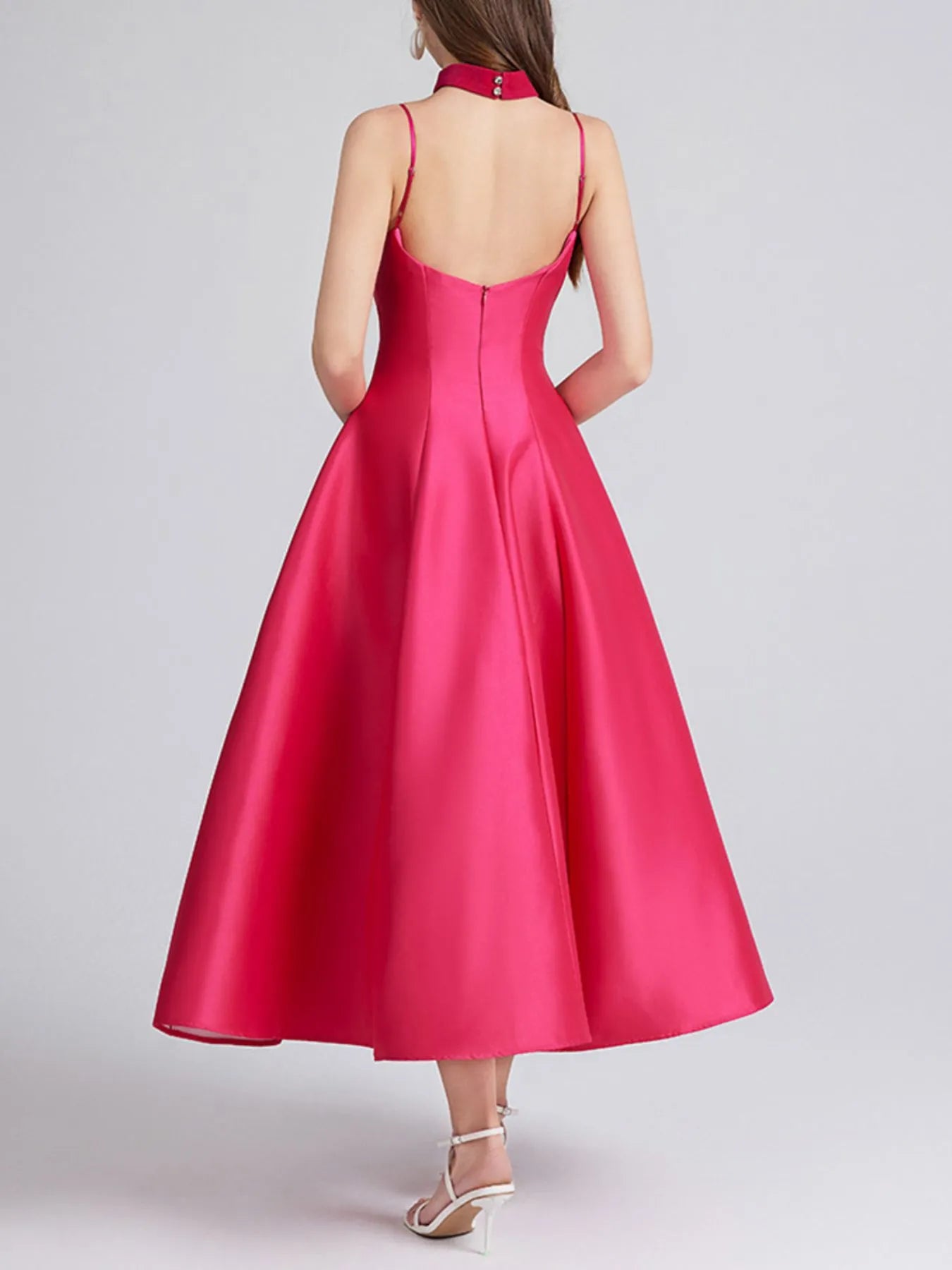 Rose red dress with thin straps on a plain background