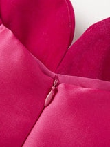 Close-up of a rose red dress top with a zipper on a white background