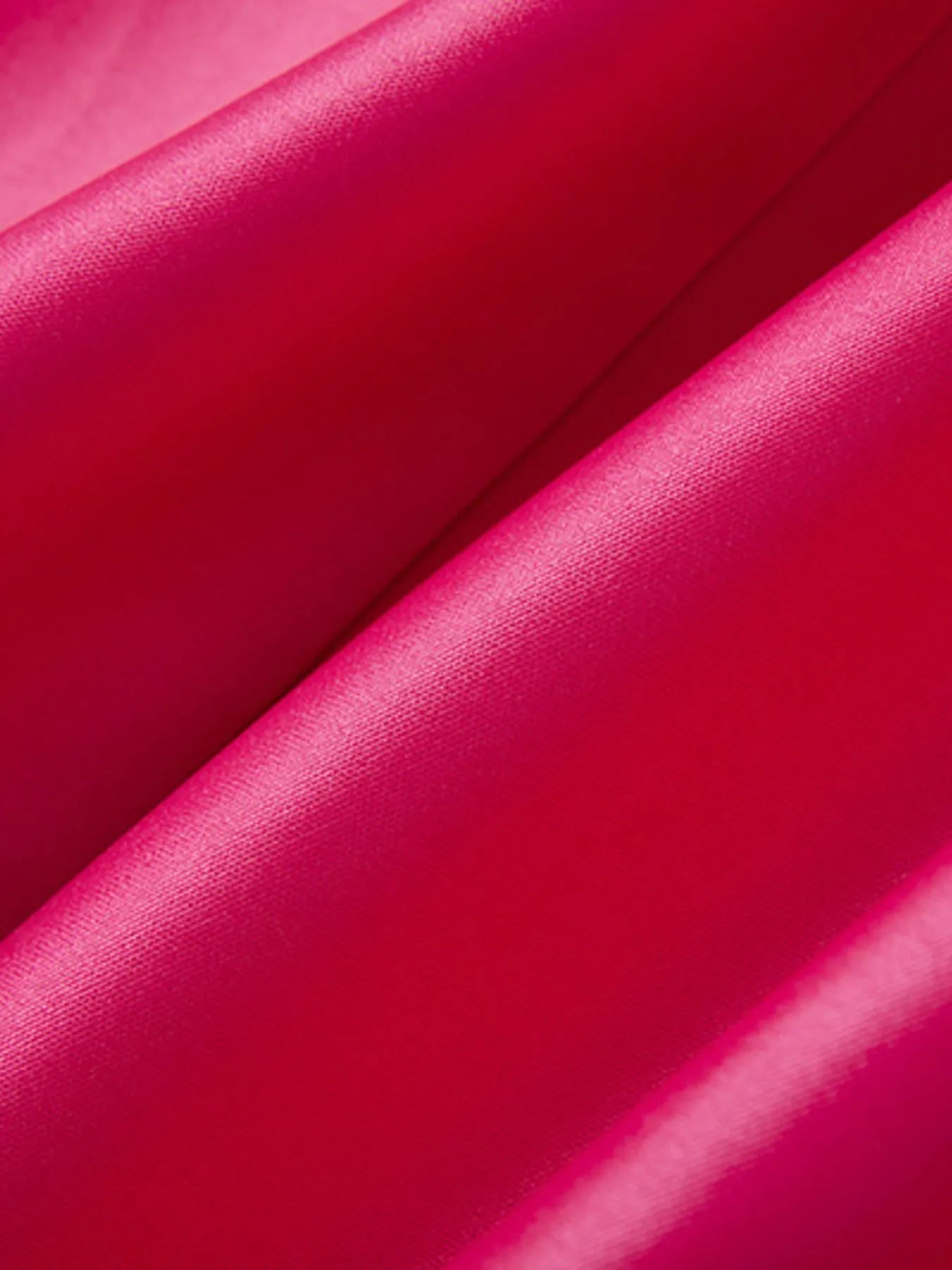 Close-up of rose red fabric with a glossy finish