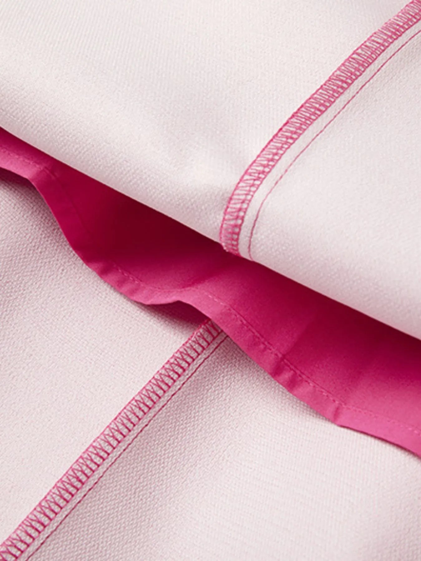 Close-up of rose red inside fabric with a visible seam on a white background