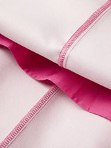 Close-up of rose red inside fabric with a visible seam on a white background