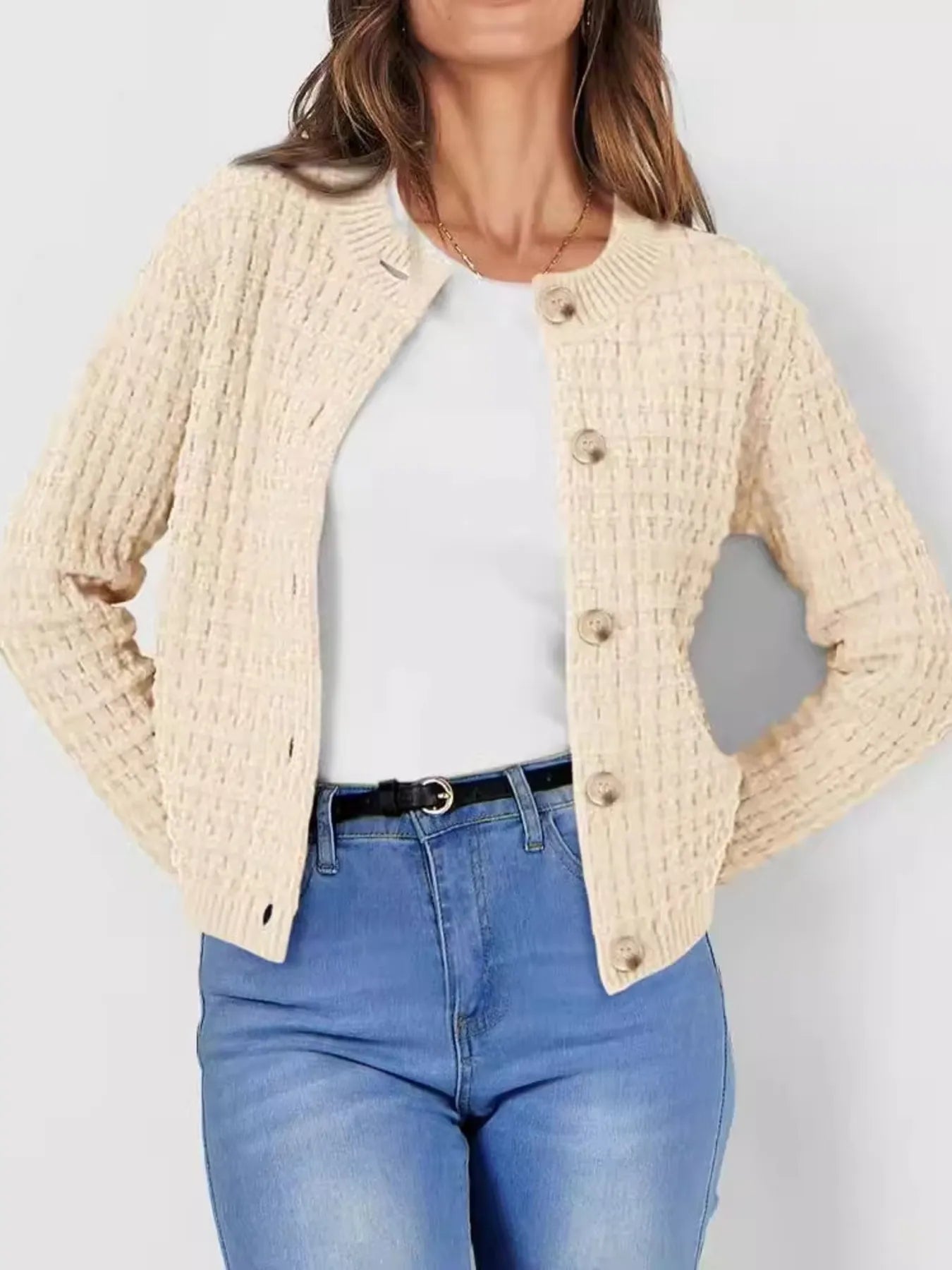 Women's button-up cable-knit cardigan in tan with long sleeves and textured knit, styled with denim for a classic fall outfit, available in sizes Small–2XL.