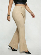 Model wearing tan plus-size high-waisted flare pants styled with pointed-toe heels for an elegant and sophisticated look.