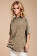 Woman wearing an oversized taupe Basic Bae round-neck half-sleeve T-shirt styled with dark denim jeans and a long pendant necklace for a relaxed, casual look.