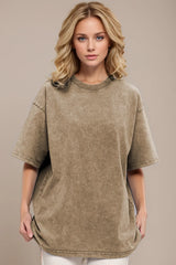 Woman wearing an oversized taupe Basic Bae round-neck half-sleeve T-shirt styled with dark denim jeans and a long pendant necklace for a relaxed, casual look.