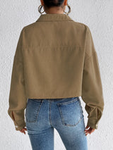 Woman wearing the Honey Snap Down Long Sleeve Jacket in taupe with blue jeans and a white top, lightweight women's fall jacket from Chic Mystik Boutique.