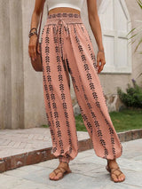 Person wearing burnt coral patterned pants standing outdoors. 