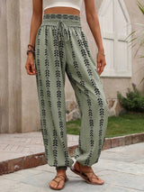 Person wearing sage patterned pants standing outdoors.