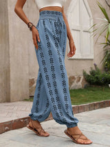 Person wearing cerulean floral-patterned pants standing outdoors.