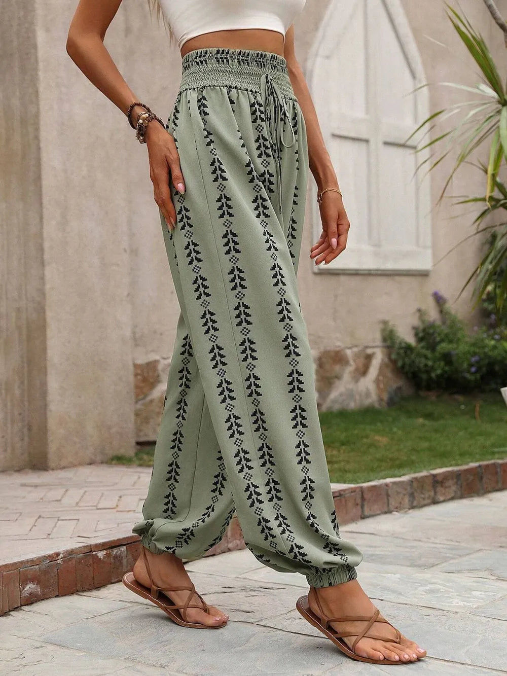 Person wearing sage patterned pants with a blurred background