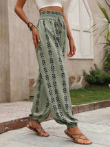 Person wearing sage patterned pants with a blurred background