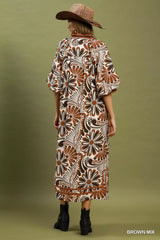 Woman wearing a patterned dress and hat on a green background