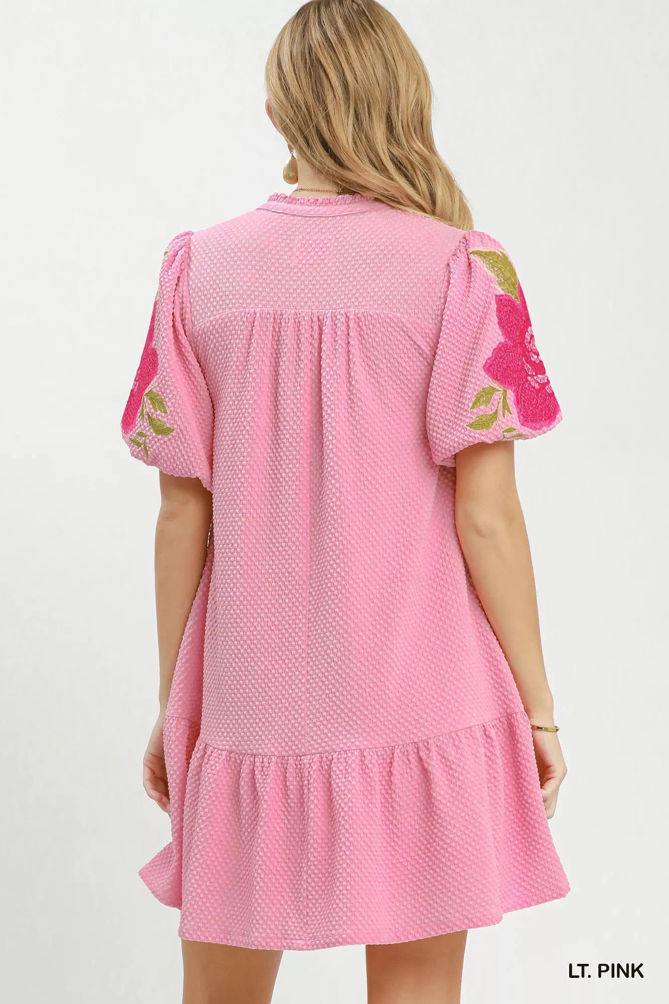 Light pink dress with floral sleeves on a white background Back of Dress