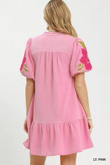 Light pink dress with floral sleeves on a white background Back of Dress
