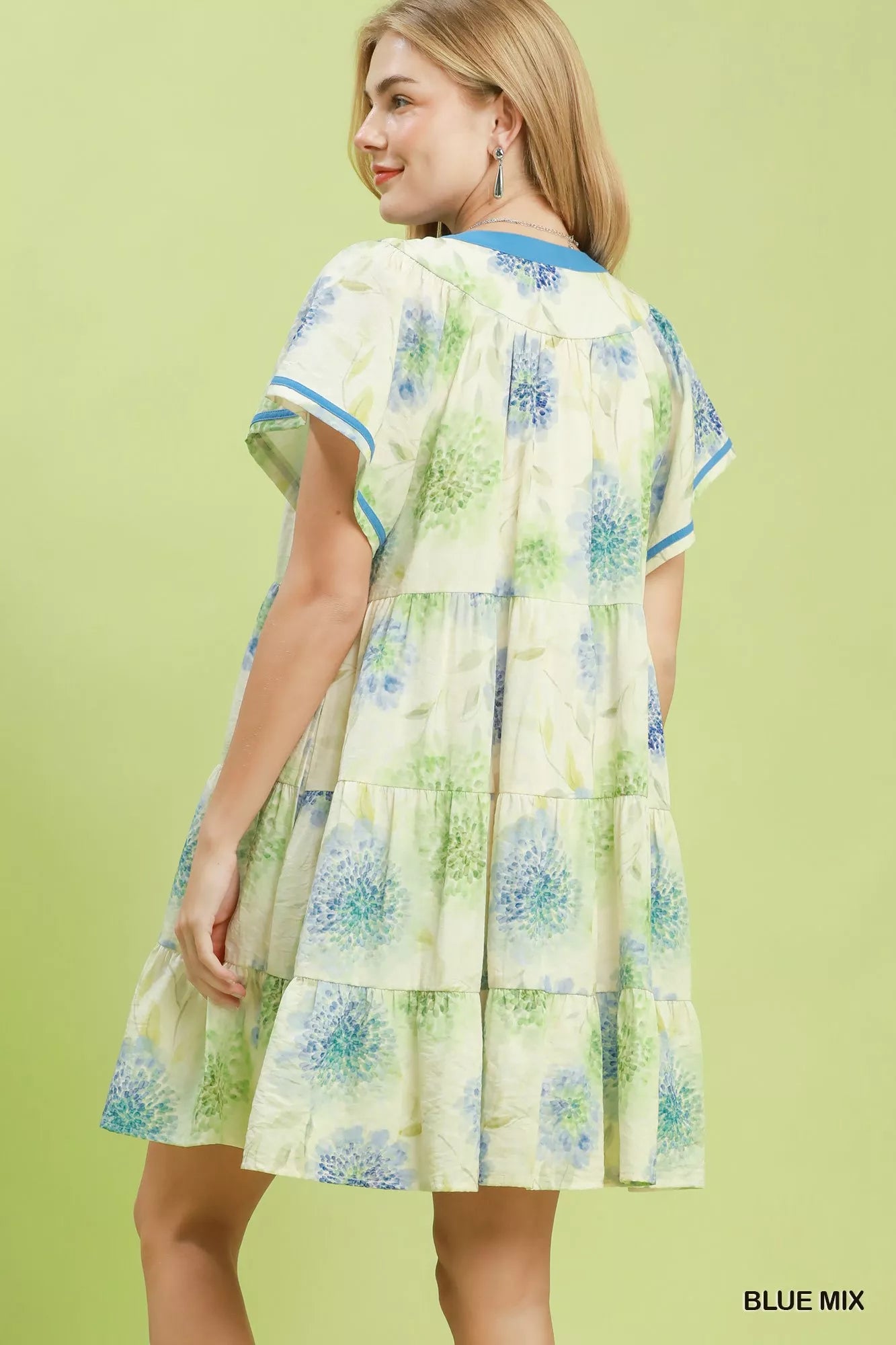 Woman wearing a floral dress with a green background