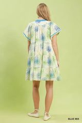 Woman wearing a floral dress on a light green background