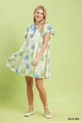 Woman wearing a floral dress on a light green background