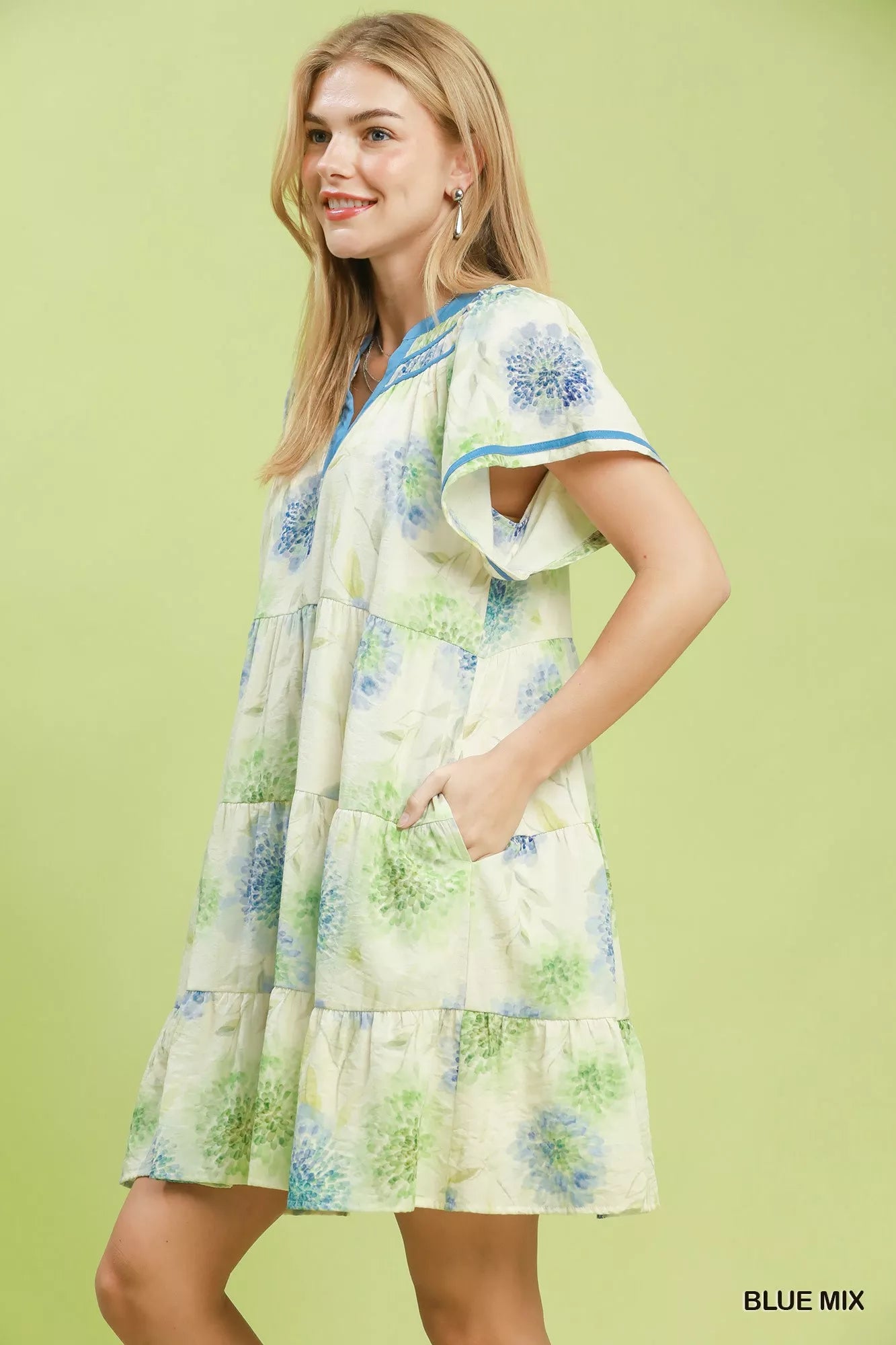Woman wearing a floral dress with a green background