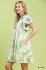Woman wearing a floral dress with a green background