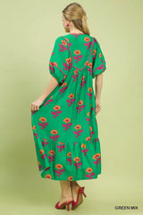 Woman wearing a green floral dress against a light green background