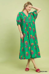 Woman wearing a green floral dress on a light green background