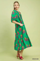 Woman wearing a green floral dress on a light green background