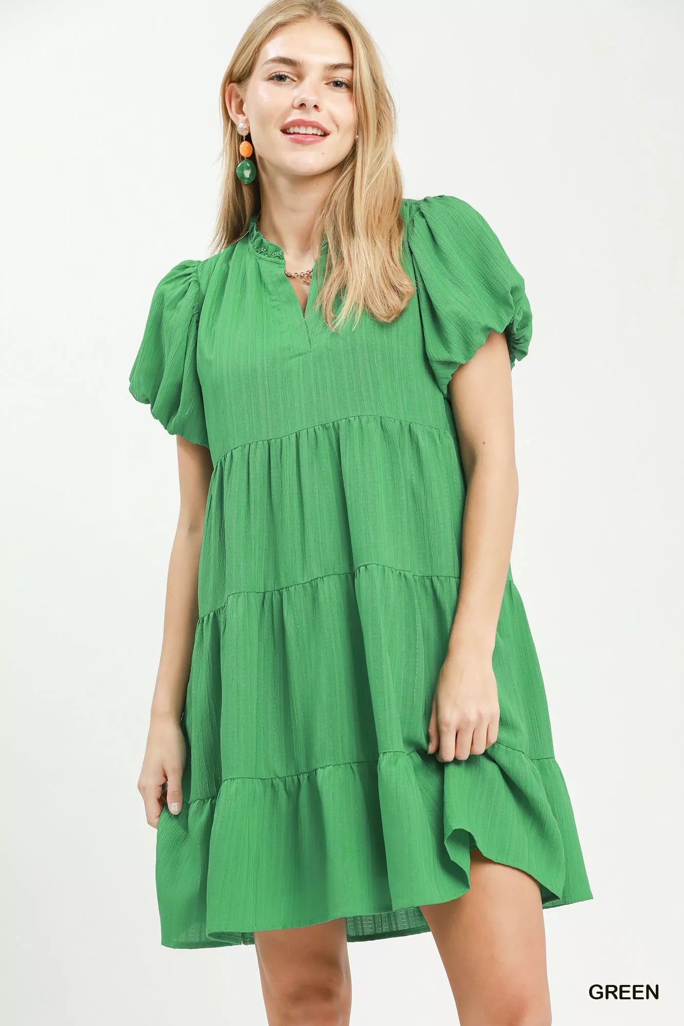 Woman wearing a green dress on a white background