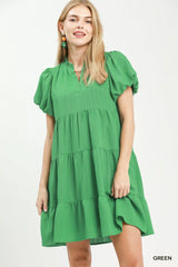 Woman wearing a green dress on a white background