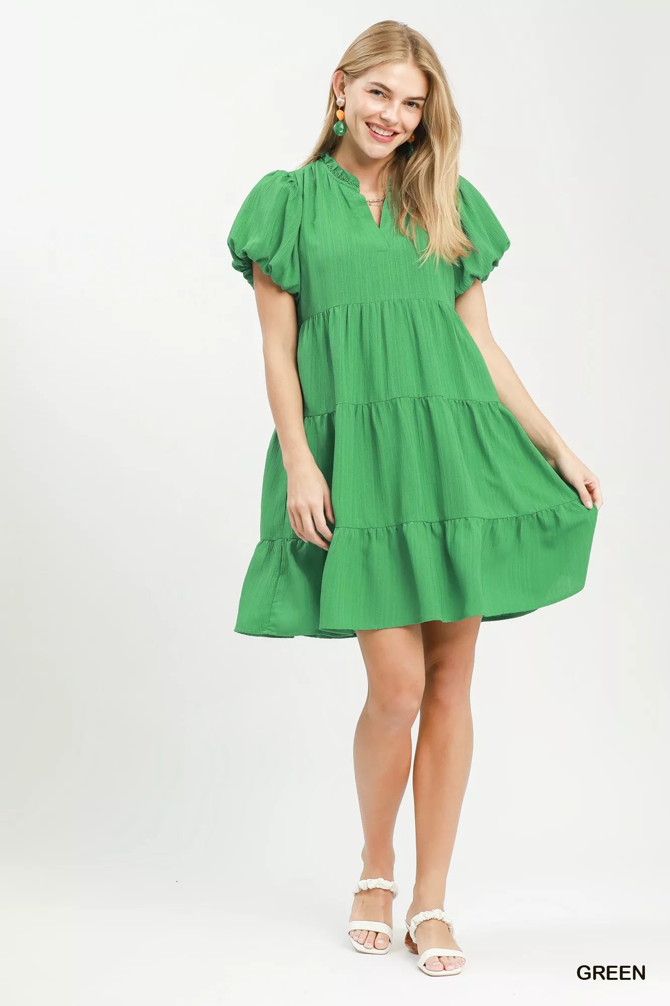 Woman wearing a green dress on a white background
