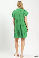 Green dress worn by a model on a white background