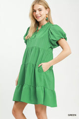 Woman wearing a green dress on a white background