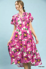 Woman wearing a pink floral dress against a light blue background