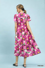 Woman wearing a pink floral dress against a light blue background